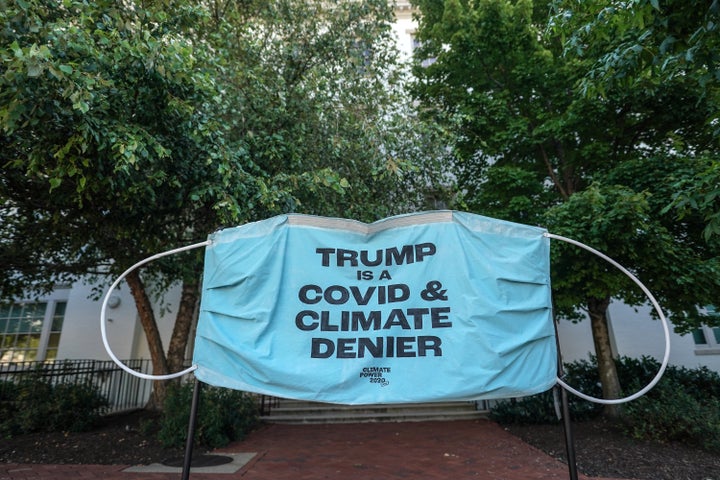 A banner protests President Donald Trump's pandemic and climate change response at the Republican National Convention's headquarters on Aug. 24.