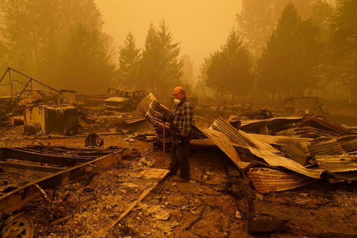 George Coble walks through what remains of a home on his property destroyed by a wildfire Saturday, Sept. 12, 2020, in Mill City, Ore. (AP Photo/John Locher)