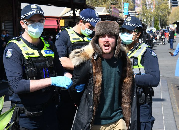 Police detain an anti-lockdown protester at Melbourne's Queen Victoria Market during a rally on September 13, 2020, amid the ongoing COVID-19 coronavirus pandemic. - Melbourne continues to enforce strict lockdown measures to battle a second wave of the coronavirus. (Photo by William WEST / AFP) (Photo by WILLIAM WEST/AFP via Getty Images)