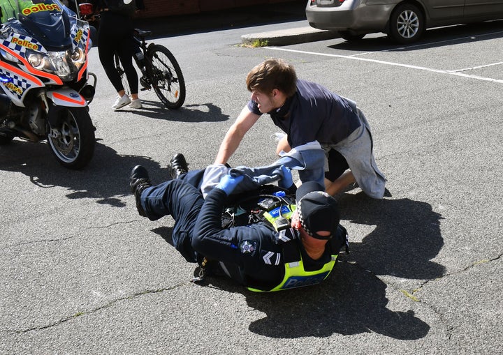 Police detain an anti-lockdown protester at Melbourne's Queen Victoria Market during a rally on September 13, 2020, amid the ongoing COVID-19 coronavirus pandemic. - Melbourne continues to enforce strict lockdown measures to battle a second wave of the coronavirus. (Photo by William WEST / AFP) (Photo by WILLIAM WEST/AFP via Getty Images)