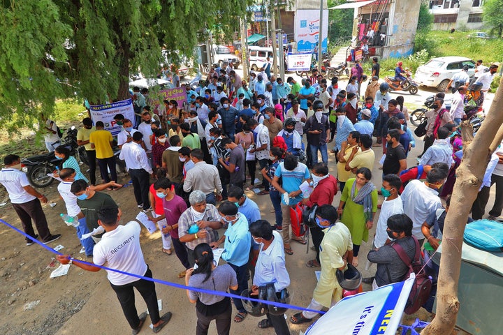 Candidates wait outside an examination centre before appearing for the NEET in Jaipur, Rajasthan on September 13, 2020.