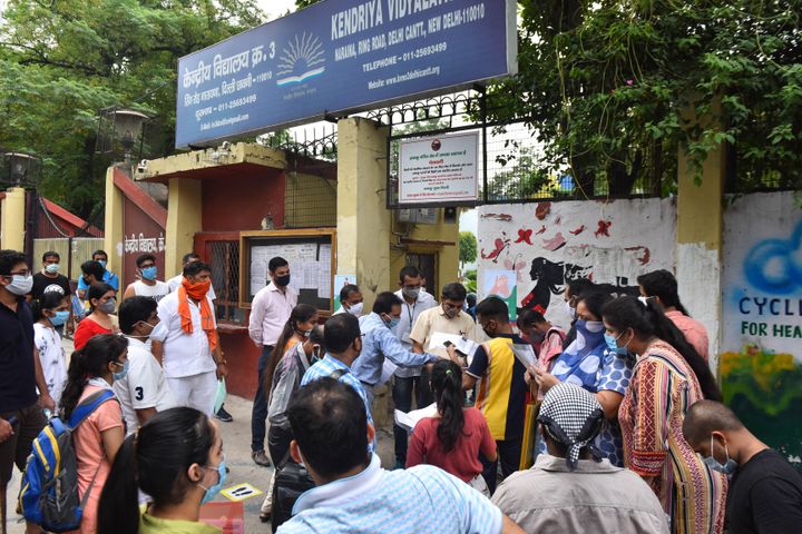 NEET aspirants and parents wait outside the examination centre at Naraina, on September 13, 2020 in New Delhi.