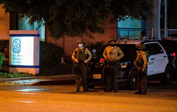 Los Angeles County Sheriff's deputies guard the entrance to St. Francis Medical Center early Monday, Sept. 13, 2020, after two deputies were shot late Saturday, Sept. 12 while sitting inside their patrol vehicle guarding a Metro station in Compton, Calif. (AP Photo/Jintak Han)