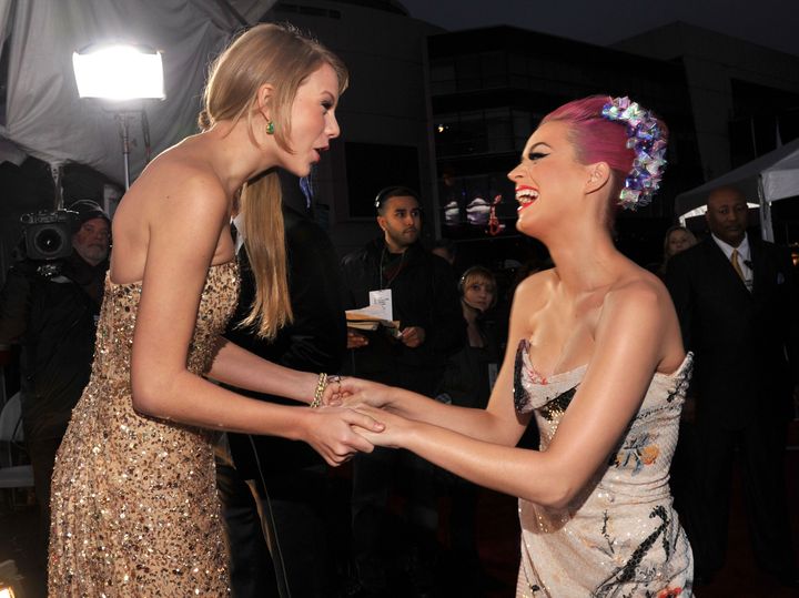 Pre-feud Taylor Swift and Katy Perry join hands at the 2011 American Music Awards.
