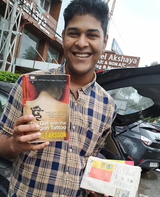 Alan displays a book presented to him by his mother Sabitha Sekhar after his release from Viyyur Central Jail in Thrissur on Friday afternoon.