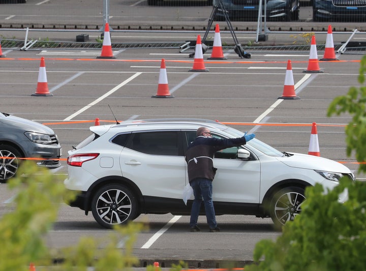 Cars are directed at the drive-in coronavirus testing facility at Ebbsfleet in Kent