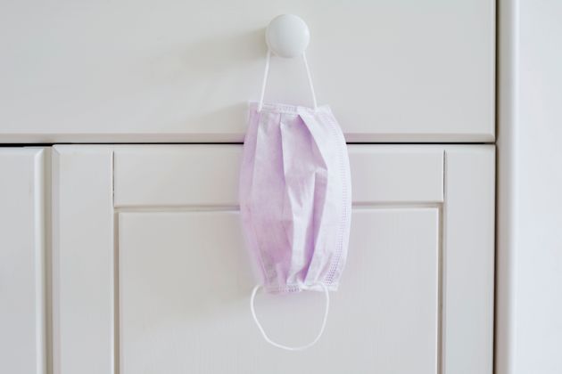 Still life of a face mask hanging at a cabinet in bedroom