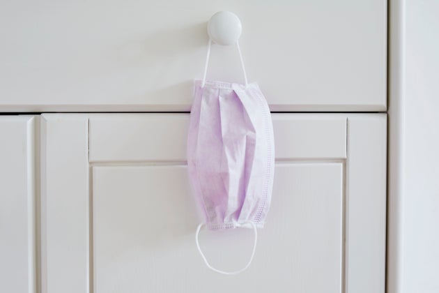 Still life of a face mask hanging at a cabinet in bedroom