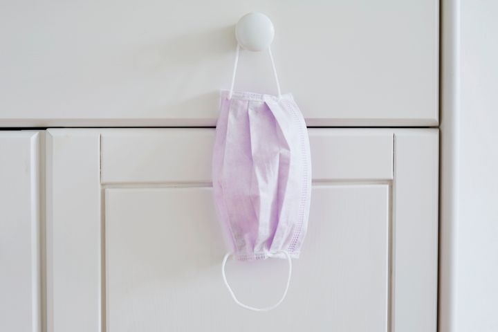 Still life of a face mask hanging at a cabinet in bedroom