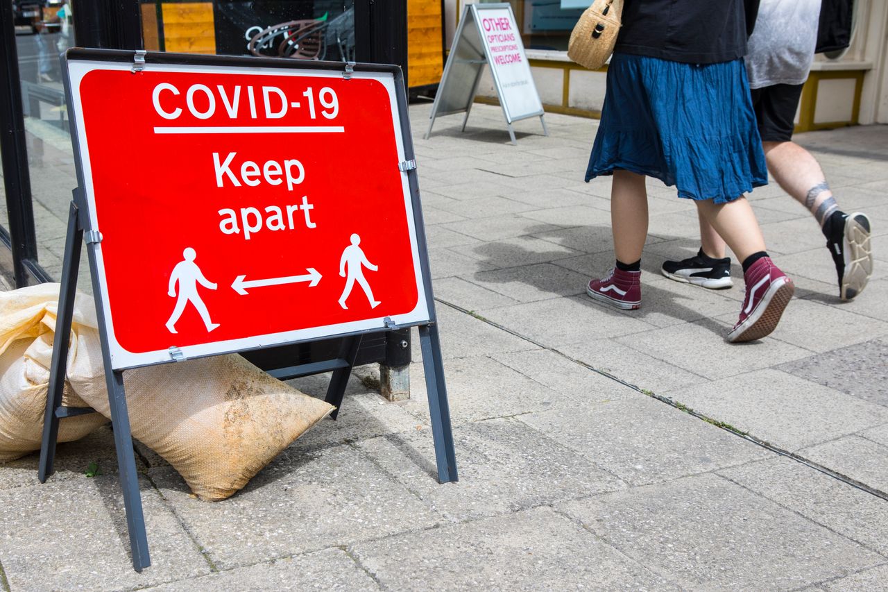 A social distancing sign asking people to keep apart when walking in the market town of Wimborne Minster in Dorset, UK.