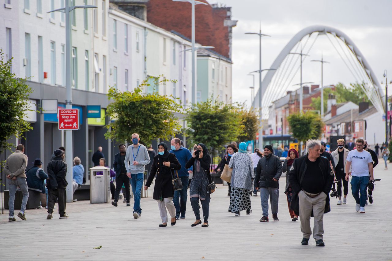 Members of the public wear face masks in Bolton town centre as coronavirus restrictions are tightened in the area on September 9.
