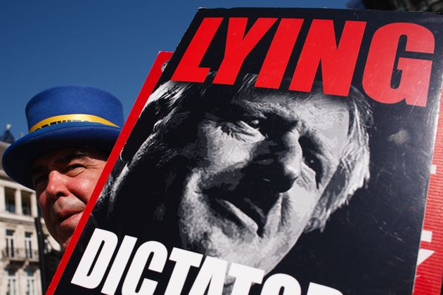 Anti-Brexit activist Steve Bray, holding a poster of British Prime Minister Boris Johnson, demonstrates ...