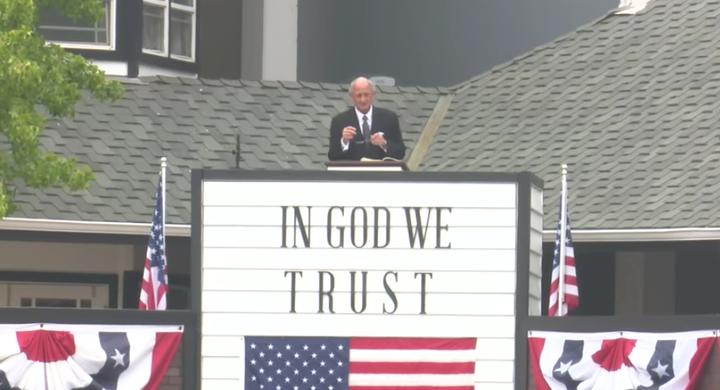 Pastor Jack Trieber preaches from a makeshift pulpit outside of North Valley Baptist Church in Santa Clara, California, on Su