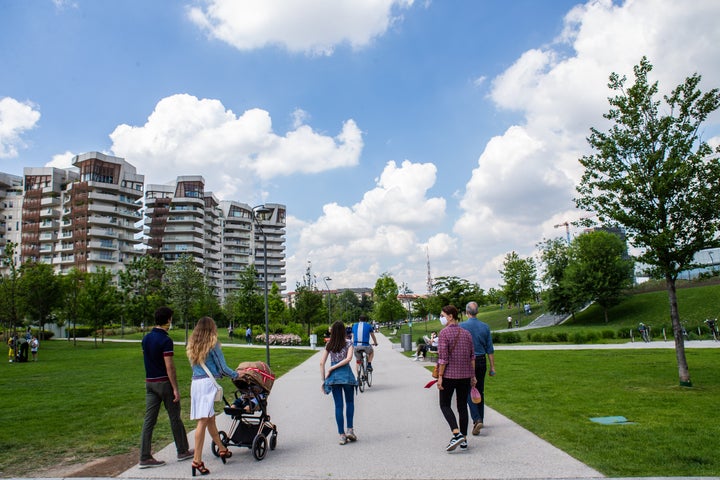 MILAN, ITALY - MAY 10: Some passersby in CityLife Park during the first sunday of phase two of the containment of the pandemic from Covid-19 on May 10, 2020 in Milan, Italy. Italy was the first country to impose a nationwide lockdown to stem the transmission of the Coronavirus (Covid-19), and its restaurants, theaters and many other businesses remain closed. (Photo by Roberto Finizio/Getty Images)