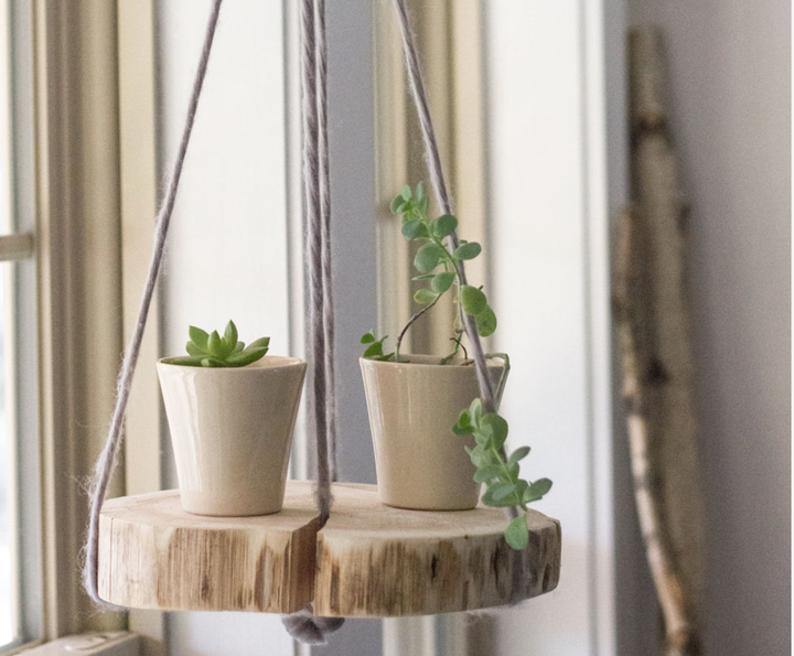 This suspended plant shelf is made with sweet-smelling cedar.