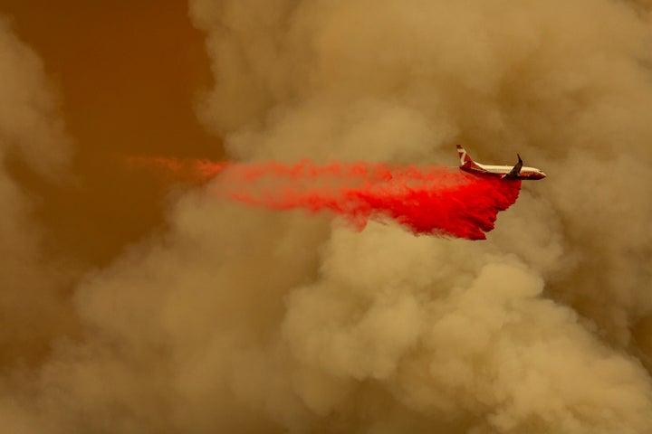 A firefighting tanker jet drops fire retardant to slow the Bobcat fire in the Angeles National Forest on Sept. 10.