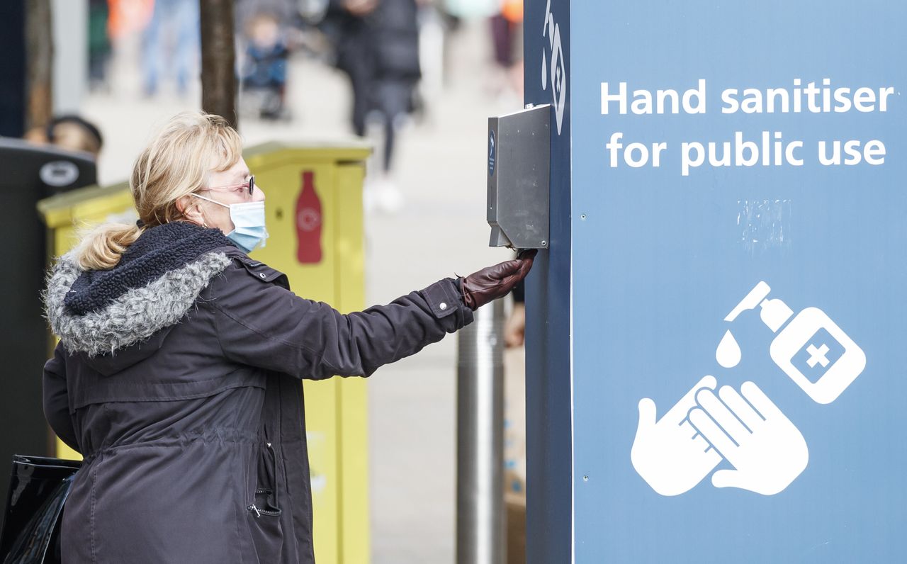 A woman uses a public hand sanitiser in Leeds city centre. 
