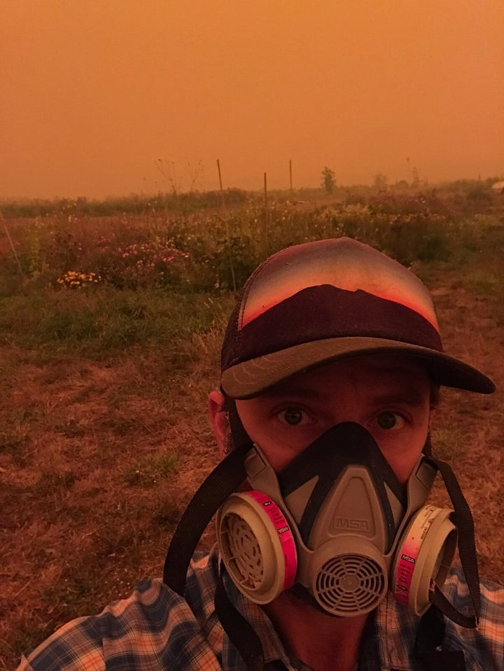 Farmer Conner Voss wears a mask at Diggin’ Roots Farm in Oregon's Willamette Valley.