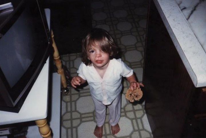 The author at age 3 in 1986. "I have always loved to eat, despite the challenges my birth anomalies have created for me in that area. This is a normal-sized cookie I am holding; I was born small."