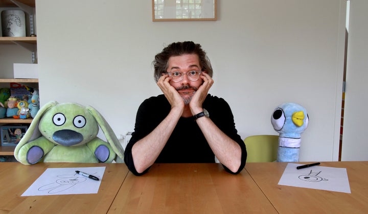 Willem poses with stuffed characters Knuffle Bunny and Pigeon at his home in Northampton, Massachusetts, in 2015.