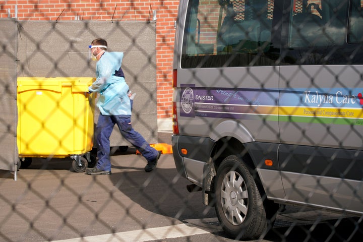 Medical personnel disposes medical waste outside the Kalyna Aged Care facility amid the second wave of the coronavirus disease.