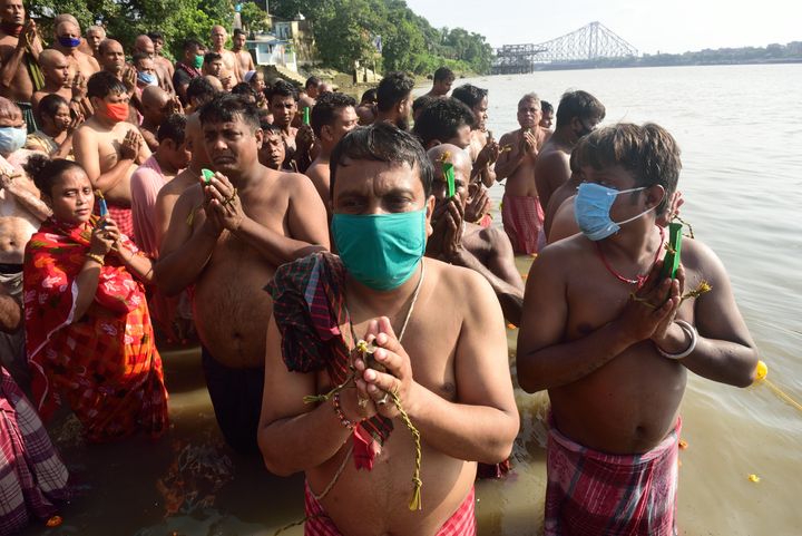 More devotees perform rituals on the banks of the Hooghly. 