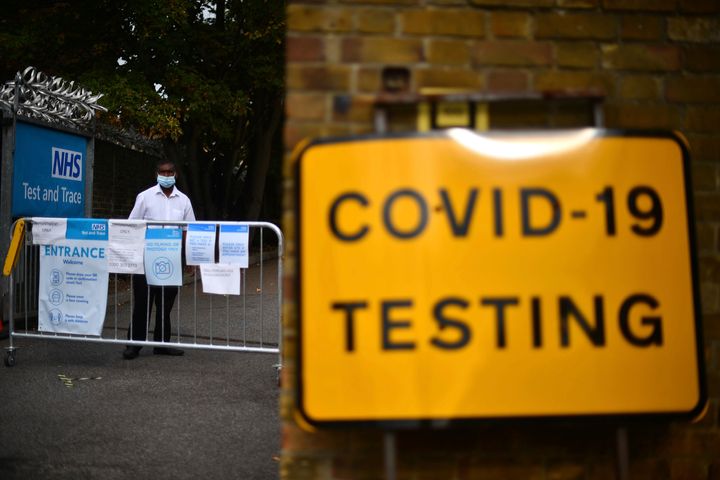 A member of staff stands at the entrance to a coronavirus testing centre in Newham, east London