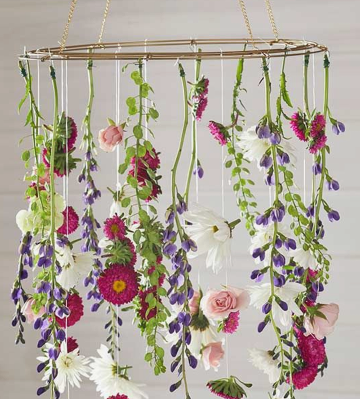 Use fresh flowers and dollar store greenery to create this hanging arrangement.