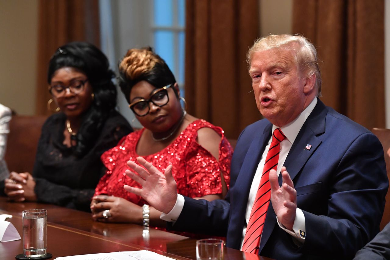 Trump speaks as social media personalities Lynnette Hardaway (L) and Rochelle Richardson (2-L), otherwise known as Diamond and Silk listen during a meeting.