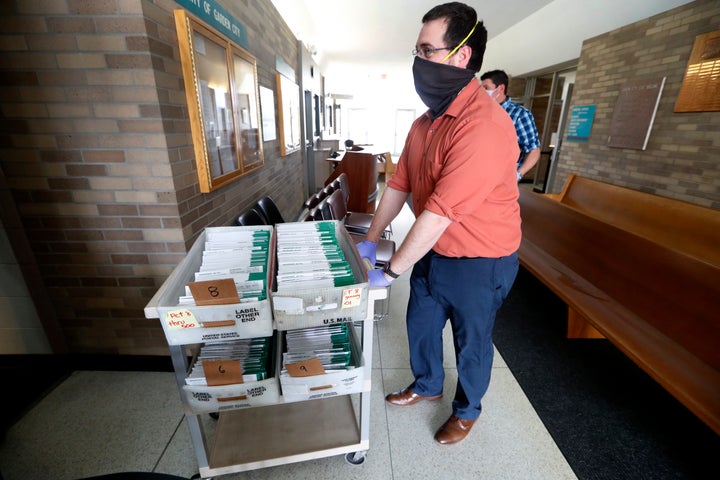 Michigan voters won't have to worry about their mailed absentee ballots (pictured above) being returned late after a judge extended the ballot receipt deadline by 14 days. (AP Photo/Paul Sancya)