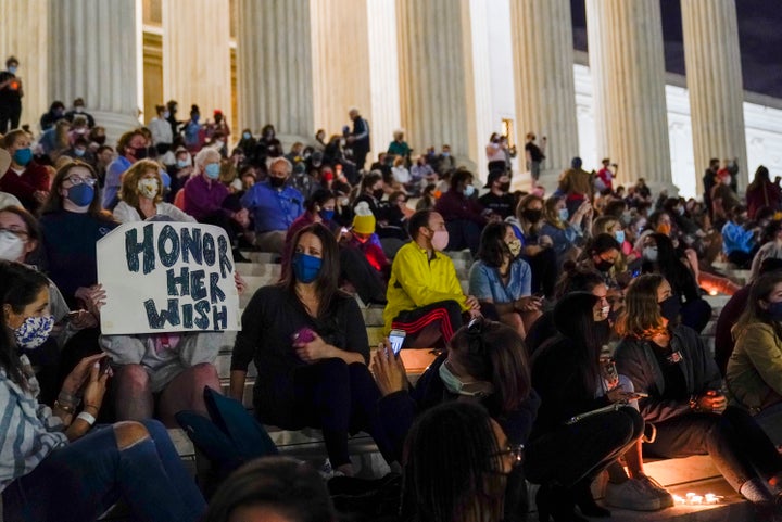 People gather at the Supreme Court on Friday night to honor Supreme Court Justice Ruth Bader Ginsburg, who died Friday night.