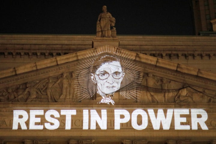 An image of Justice Ruth Bader Ginsburg is projected onto the front of the New York State Civil Supreme Court building in Manhattan.