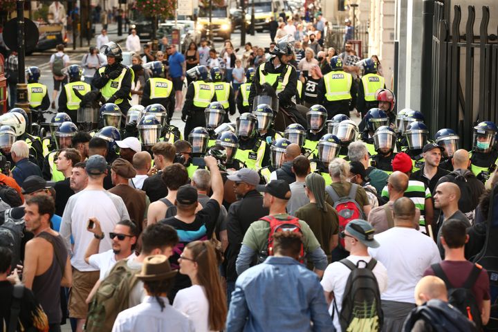 Police presence among demonstrators during an anti-vax protest in London's Trafalgar Square.
