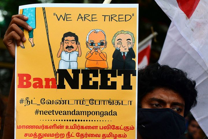A member of the Democratic Youth Federation of India (DYFI) holds a placard and shouts slogans against the National Eligibility Cum Entrance Test (NEET)-2020, the largest and one of the most competitive medical entrance exam in India, in Chennai on September 13, 2020. (Photo by Arun SANKAR / AFP) (Photo by ARUN SANKAR/AFP via Getty Images)