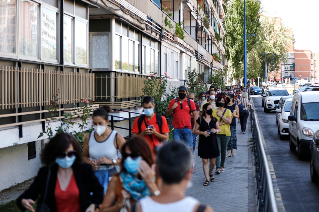 Teachers and administrative staff wait near the María Zambrano Secondary School for coronavirus tests on Sept. 3 in Madrid. There have been reports of people having to wait for days to more than a week for results.