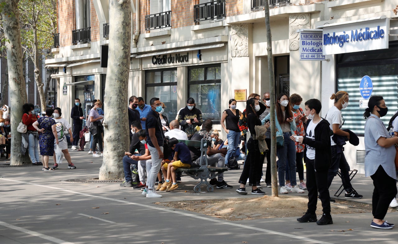 People wait in line at a testing site for COVID-19 in Paris on Sept. 11. Lab workers in France say they have become overwhelmed.