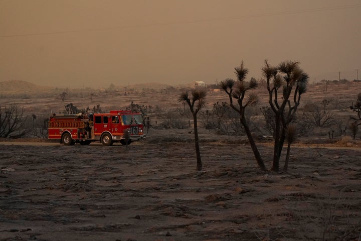 A fire engine is driven through the devastation left behind by the Bobcat Fire on Saturday, Sept. 19, 2020, in Juniper Hills,