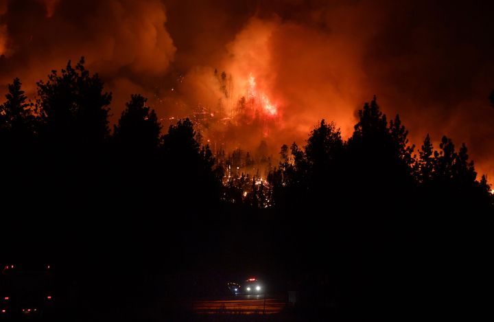 Firefighters rush up Highway 38 as the El Dorado Fire burns in heavy timber north of Angelus Oaks, Calif., Thursday, Sept. 17, 2020. (Will Lester/The Orange County Register via AP)