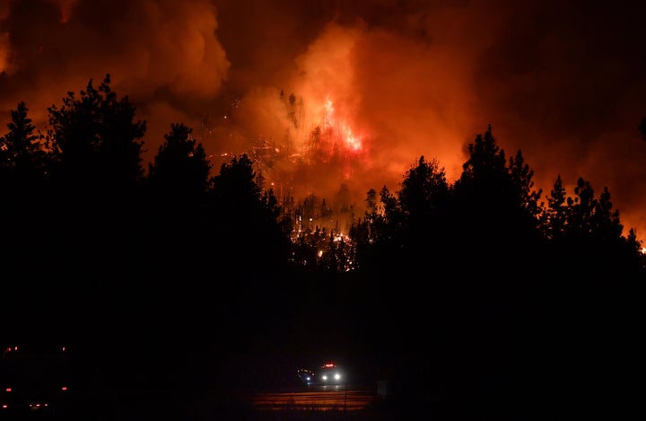 Firefighters rush up Highway 38 as the El Dorado Fire burns in heavy timber north of Angelus Oaks, Calif., Thursday, Sept. 1