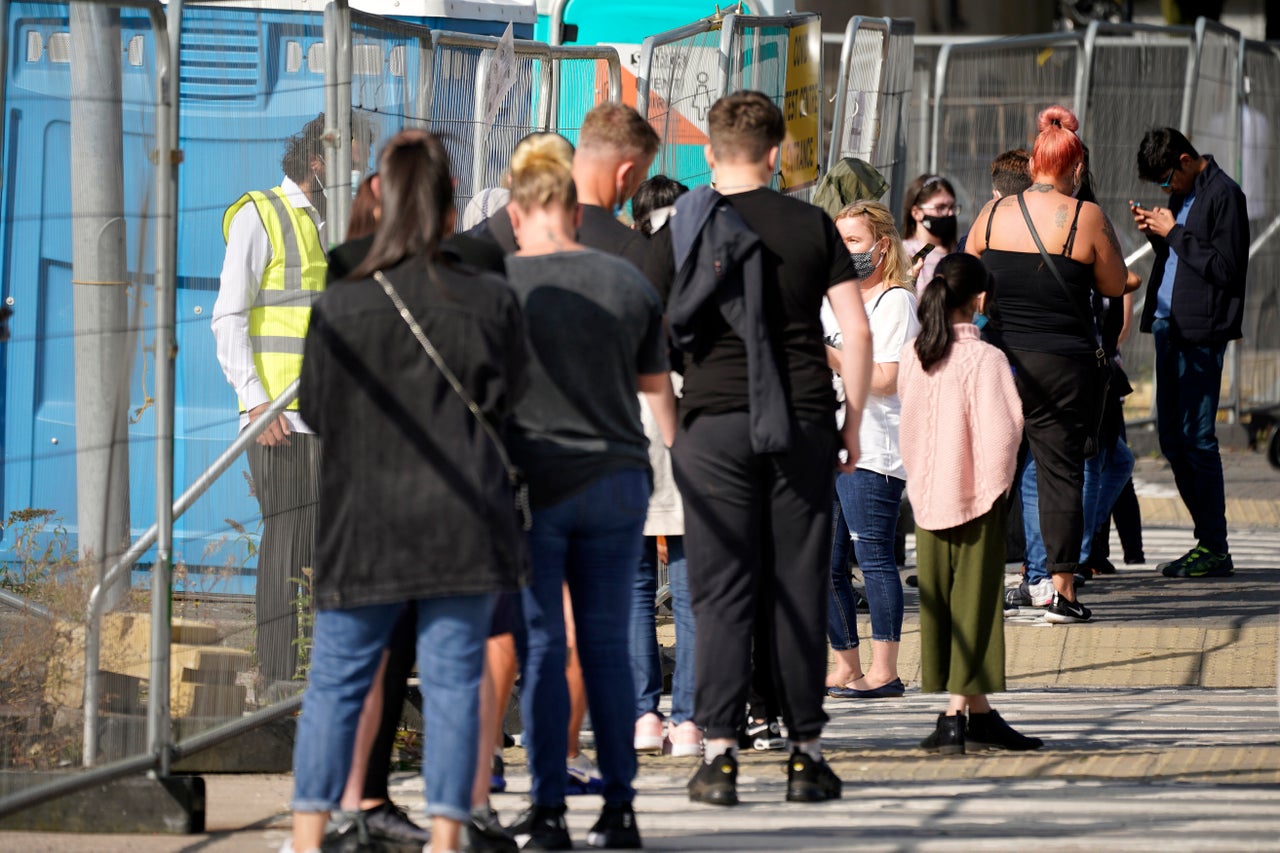 People queue at a walk-in Covid-19 testing centre in Bolton where many people with appointments were turned away.