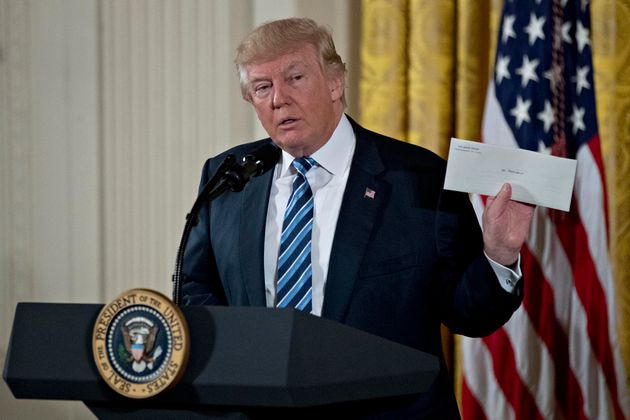 Donald Trump sostiene un sobre con la carta personal que Barack Obama le dejó en el Despacho Oval...