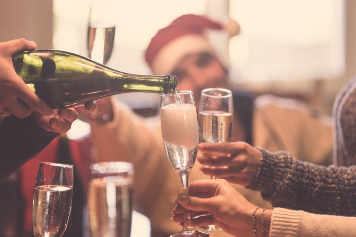 Cropped image of people toasting with champagne celebrating Christmas