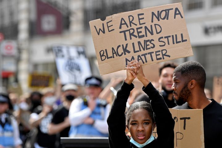 A protester holds up a sign during a Black Lives Matter march in London in June