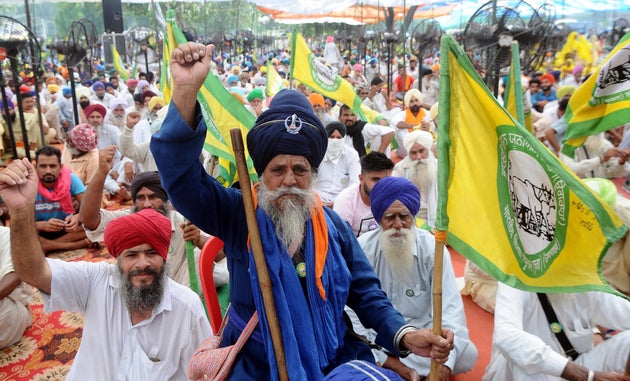 Farmers raise slogans during a protest in Punjab against the Electricity Amendment Bill 2020 and the...