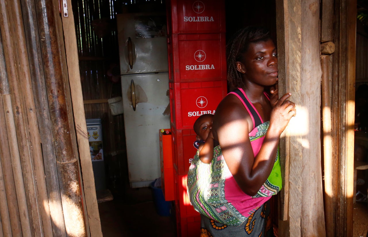 A woman and child near a cocoa farm in the village of Monga, in Alepe, Ivory Coast. Cocoa farmers live in poverty while working as suppliers for cocoa companies