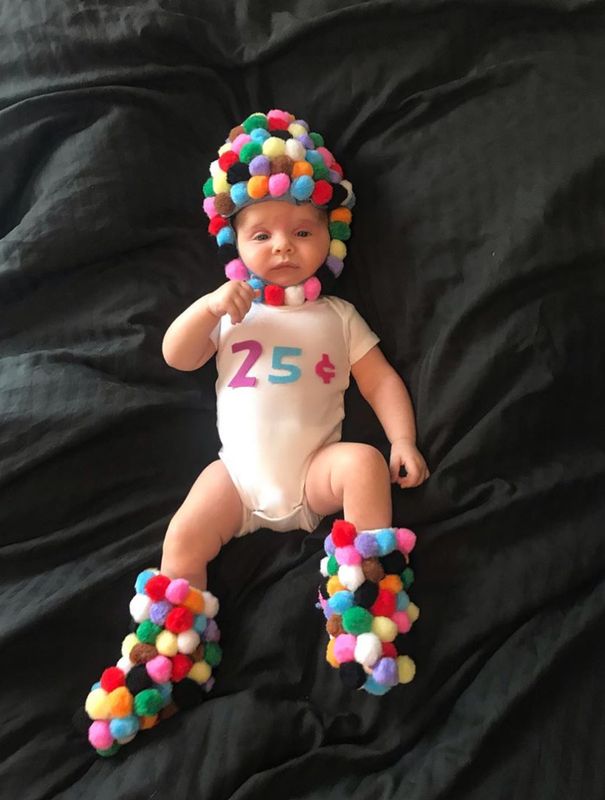 This candy-themed costume has been crafted with colourful pompoms, glued to a tiny bonnet and sock boots. So sweet! 