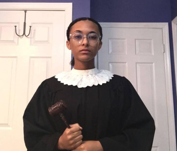 Leyla Fern King dresses up as Justice Ruth Bader Ginsburg, complete with a white collar and gavel.