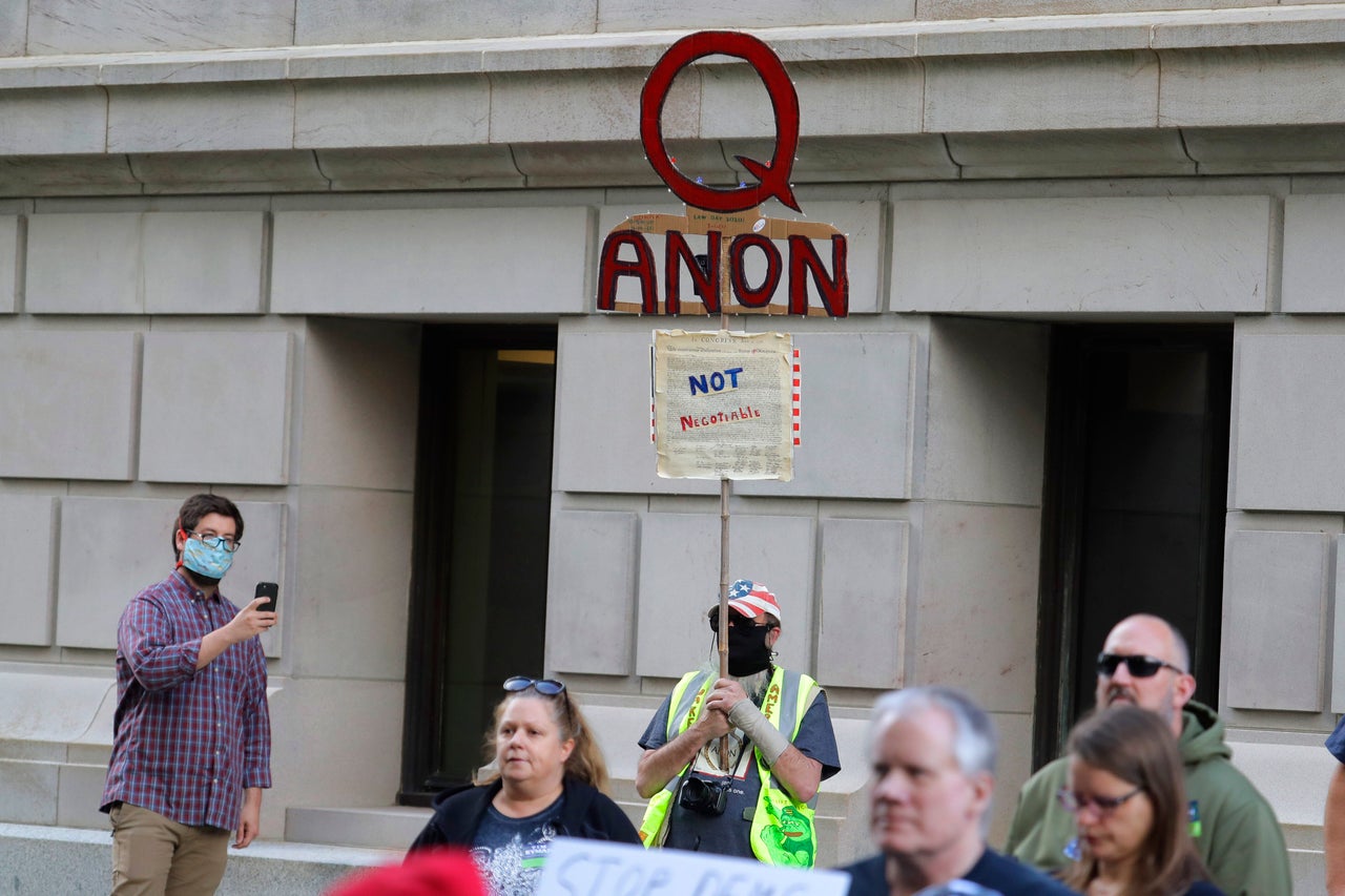 Supporters of the QAnon conspiracy theory, seen here at a May rally in Olympia, Washington, have been behind much of the trafficking misinformation circulating online this summer.