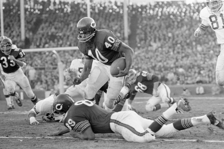Chicago Bears RB Gale Sayers finds an open spot and leaps over teammate Bob Wallace (89) in a 1969 game against the Cleveland