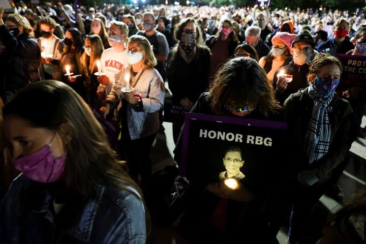 People gather outside the U.S. Supreme Court for a vigil Saturday following the death of Supreme Court Justice Ruth Bader Ginsburg.